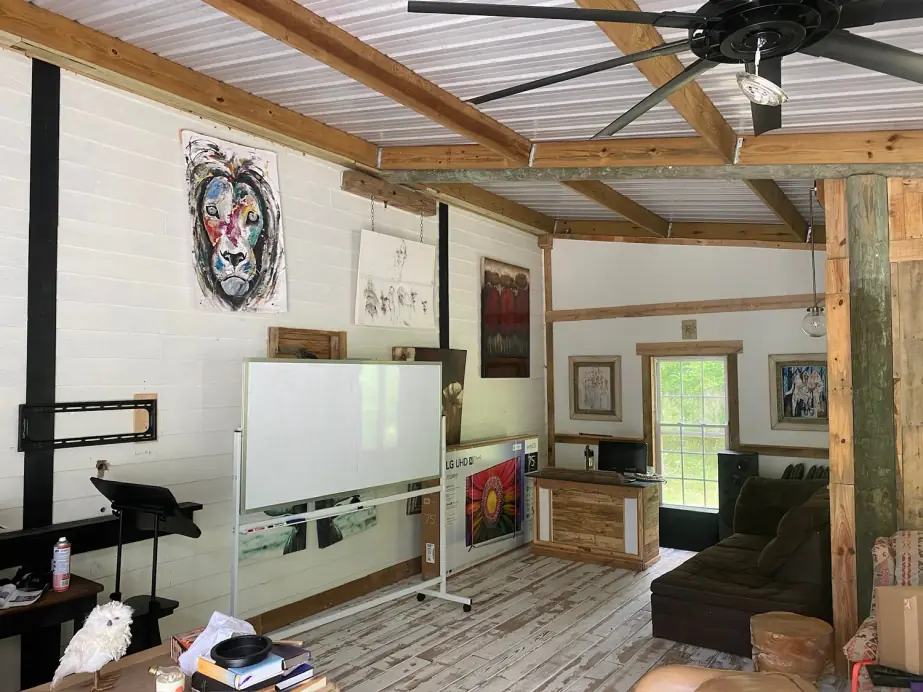The Still Worthy common room: whitewashed boards, exposed timber and a painted lion on the wall