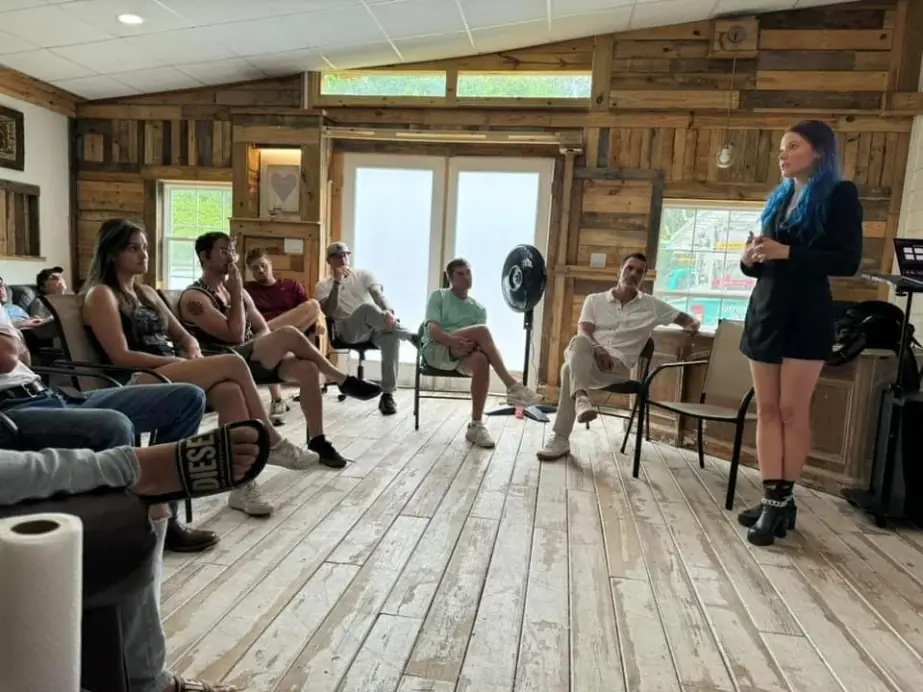 Still Worthy fellowship gathered in the rustic hall while one man speaks